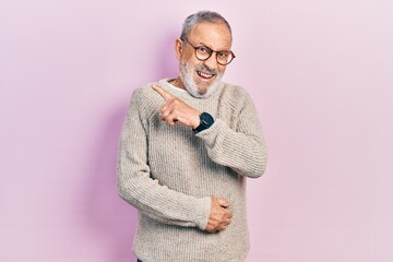 Sticker - Handsome senior man with beard wearing casual sweater and glasses pointing aside worried and nervous with forefinger, concerned and surprised expression