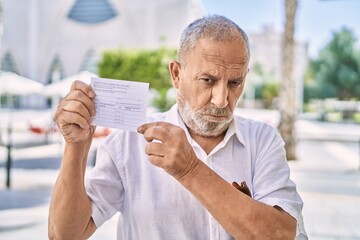 Poster - Mature doctor man holding covid record card depressed and worry for distress, crying angry and afraid. sad expression.