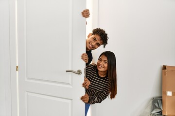 Poster - Young latin couple smiling happy getting in at new home.