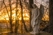 © Westend61 - Germany, Hesse, Brechen, Outdoor angel statue at sunrise
