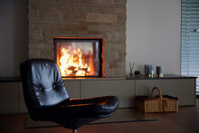 Empty Black Chair By Fireplace At Home