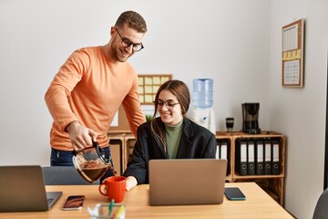 Sticker - Two caucasian business executives working and drinking coffee at the office.