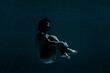 © Westend61 - Young woman in fetal position swimming underwater