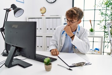 Sticker - Young caucasian doctor man working at the clinic feeling unwell and coughing as symptom for cold or bronchitis. health care concept.