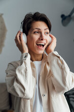 Cheerful Woman With Headphones Listening To Music
