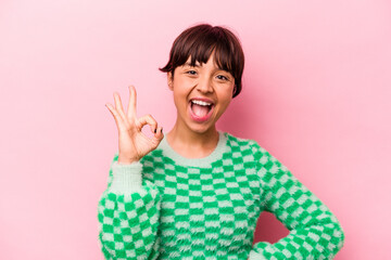 Wall Mural - Young hispanic woman isolated on pink background cheerful and confident showing ok gesture.