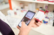 © Westend61 - Pharmacist scanning barcode of medicine box through smart phone at pharmacy store