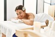 © Krakenimages.com - Young latin woman smiling confident lying on massage table at beauty center