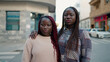 © Krakenimages.com - Two african american friends with serious expression hugging each other standing at street