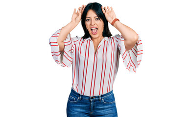 Young hispanic girl wearing casual clothes smiling cheerful playing peek a boo with hands showing face. surprised and exited