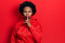 Young African American Woman Wearing Casual Sweatshirt Asking To Be Quiet With Finger On Lips. Silence And Secret Concept.