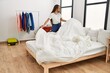 © Krakenimages.com - Young hispanic woman smiling confident make bed at bedroom