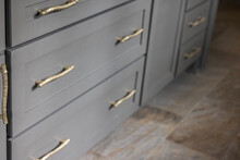 Gray Kitchen Cabinets With Modern Gold Drawer Pulls In A Recently Renovated Kitchen