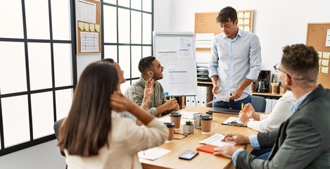 Wall Mural - Group of business workers listening boss conference during meeting at the office.