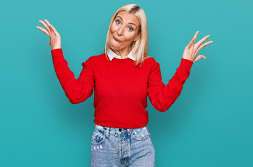 Sticker - Young blonde woman wearing casual clothes celebrating victory with happy smile and winner expression with raised hands