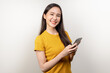 © Pormezz - Happy asian woman holding smartphone and showing hand sign ok isolated on background