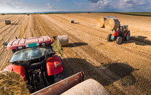 Bale On Tractor Trailer In Farm Field