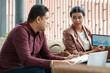 © DragonImages - Businesswoman pointing at chart on tablet computer when talking to chief marketing office,