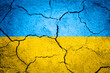 Textured background of cracked dry earth in the shape of ukrainian flag colors.