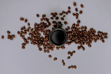 coffee beans and espresso mug on a purple background