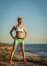 United States, California, Laguna Beach, Athlete Woman In Sports Clothing Standing On Beach