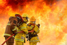 Fireman,Firefighter Training Firefighters Using Water And Fire Extinguishers To Fight The Flames In Emergency Situations. In A Dangerous Situation All Firefighters Wear Firefighter Uniforms For Safety