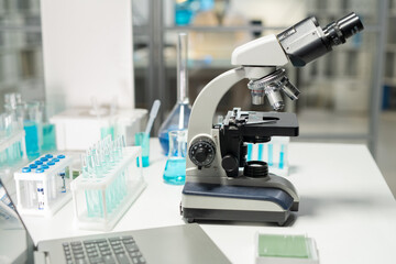 Poster - Workplace of contemporary researcher or scientist in clinic laboratory equipped with microscope, flasks and laptop