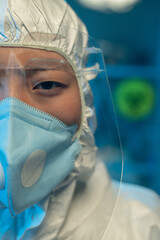 Aufkleber - Half of face of young Asian woman in coveralls, respirator and protective eyeglasses standing in front of camera in scintific laboratory