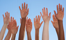 Solidarity Through Diversity. Cropped Shot Of A Diverse Group Of People Raising Their Hands.