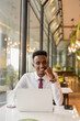 © Ranta Images - Handsome young African businessman in coffee shop restaurant