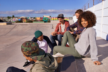 Poster - Socializing at the skatepark. Shot of a group of friends socializing at the skatepark.
