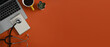 © Prathankarnpap - Top view computer laptop, stethoscope, notepad and coffee cup on orange background with copy space.