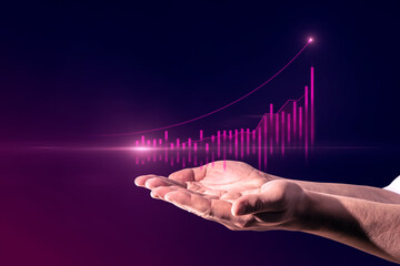 Poster - Close up of businessman hand holding abstract glowing growing global business chart on blurry purple background. Financial growth and trade concept.