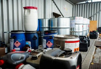 metal and plastic barrels containing hazardous chemicals from industry, waste management concept, bu