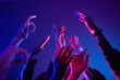 © Seventyfour - Close up of crowd dancing in club with hands up lit by neon lights, copy space