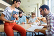 © NDABCREATIVITY - Happy group of students studying and working together in a college library