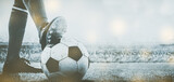 Fototapeta Sport - feet of soccer player tread on soccer ball for kick-off in the stadium