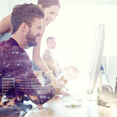 Poster - Shared vision brings shared success. Multiple exposure shot of coworkers using a computer together superimposed over a city background.