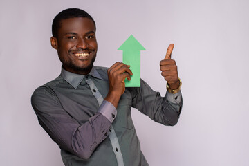 Wall Mural - black man holding an arrow pointing upwards