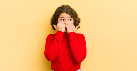 Wall Mural - pretty hispanic woman looking worried, anxious, stressed and afraid, biting fingernails and looking to lateral copy space