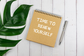 Wall Mural - Directly above of time to renew your self text on brown paper notes with green leaf and pen
