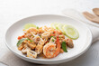 © Kritchai - Seafood Tom Yum Fried Rice,Stir fried rice with shrimp squid and straw mushroom with sauce on white plate