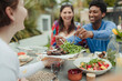 © Caia Image - Happy friends enjoying vegetarian lunch at patio table