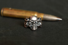 Silver Ring With A Skull And A Bullet On A Dark Background, Death And Fear And War, Weapons