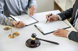 © Freedomz - Judge gavel with scales of justice, Businessman and lawyer or counselor consulting and discussing contract papers at law firm in office