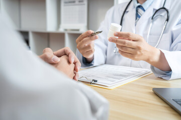 Wall Mural - Doctor discussing with the patient using the medicine something and recommend treatment methods, Presenting results on report, Medicine and Healthcare concept