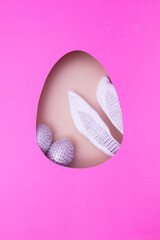 Wall Mural - Easter egg cut out of paper and bunny ears with eggs. Easter holiday concept