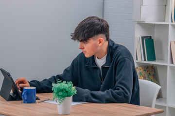 Canvas Print - teenage student at desk with digital tablet