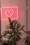 Bright luminous digital neon sign for a store or card beautiful shiny with a love heart.