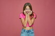 Scared child girl frightened terrified by domestic violence on pink studio background. Fear emotion. Children's fears